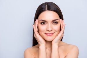 Gorgeous aesthetic woman with natural makeup enjoying her flawless perfect skin after laser procedure